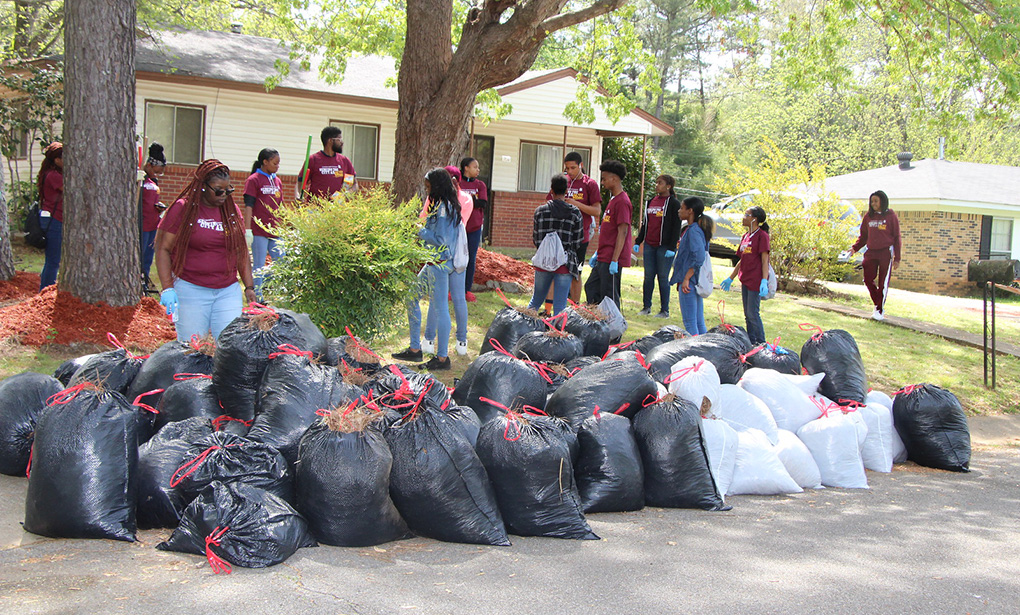 Students cleaning up yard