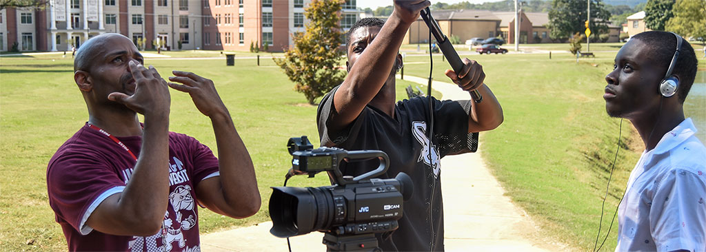 Communications Media students operate a video-camera and boom-mike under the guidance of a Communications Media instructor
