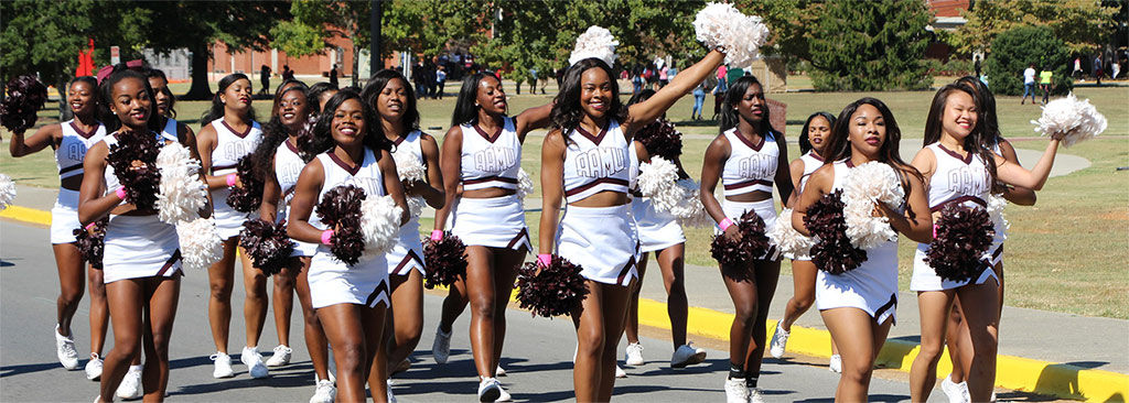 Cheerleaders march during the on-campus Homecoming parade